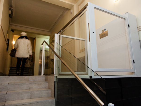 a woman who has accessed the portal using a vertical platform lift