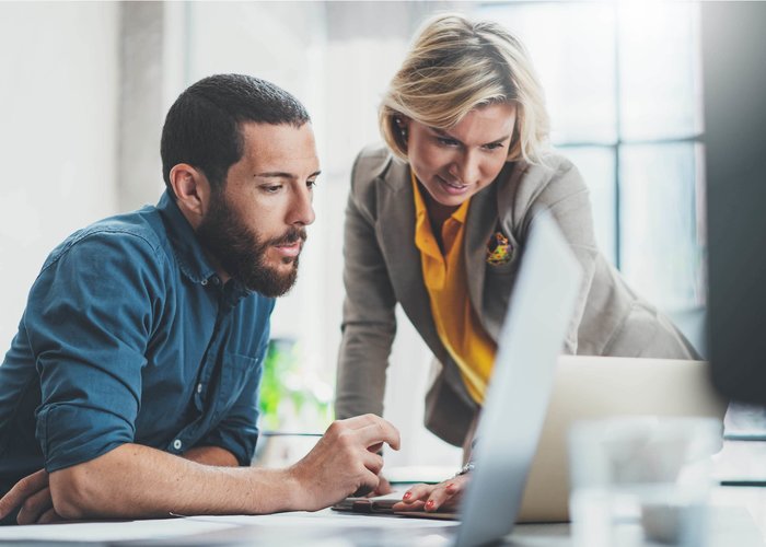 woman and man working in front of the computer