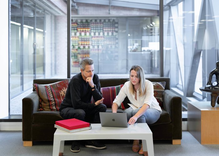 man and woman at the computer in a spacious office